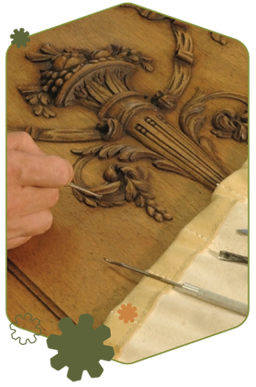 Find-a-Repairer-Hero-Image Man working with woodworking tools to repair a detailed wooden carving.