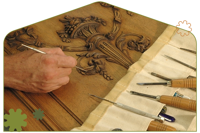 find-a-repairer-top-image-mobile Man working with woodworking tools to repair a detailed wooden carving.