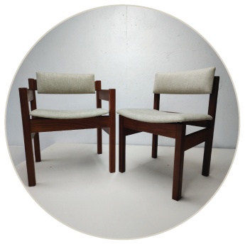 testimonial-charlotte Two reupholstered Gordon Russell dining chairs standing up on a workbench.