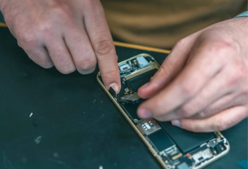 phone repair Pair of hands mending the electronics inside a phone