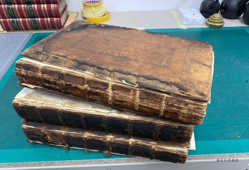 Torn old books Three torn, stained old books