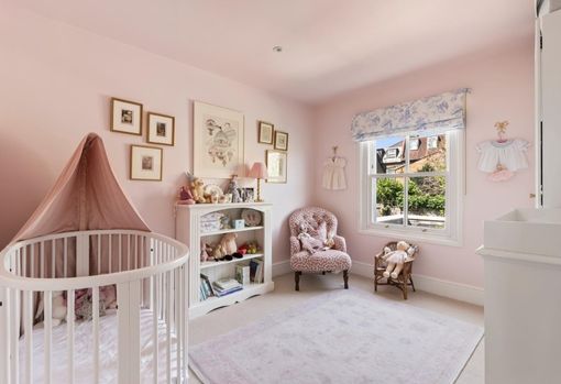 muse-bespoke-02 Pink childrens nursery with an upholstered chair in the corner