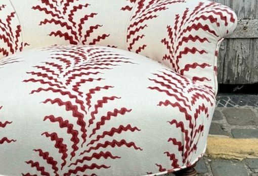 muse-bespoke-06 Close up of an upholstered chair in a cream and red fabric