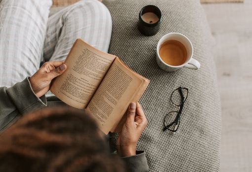 read-a-book Woman curled up on the sofa, reading a book