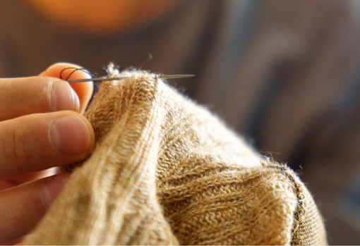 darning-jumper-02 Woman darning and repairing a hole in her jumper